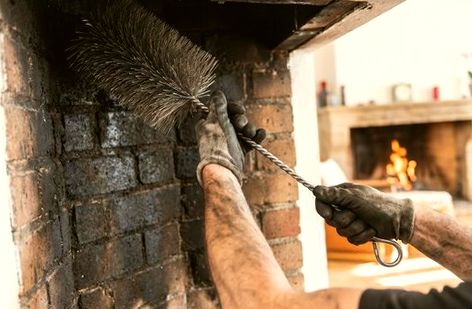 Wire brush cleaning soot from a firebox wall
